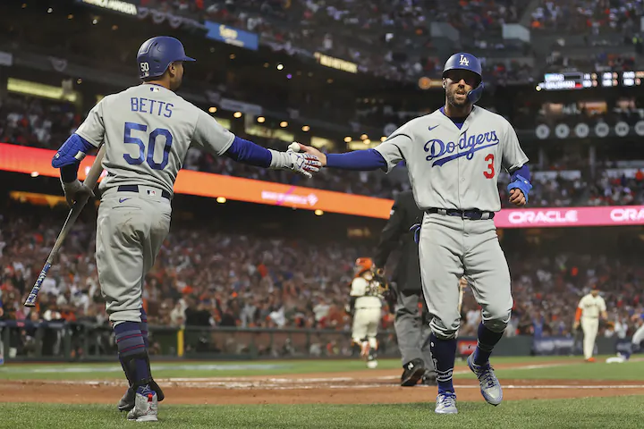 Los Angeles Dodgers’ Chris Taylor (3) is congratulated by Mookie Betts (50) after scoring against the San Francisco Giants during the second inning of Game 2 of a baseball National League Division Series in San Francisco on Oct. 9, 2021. (AP Photo/John Hefti)