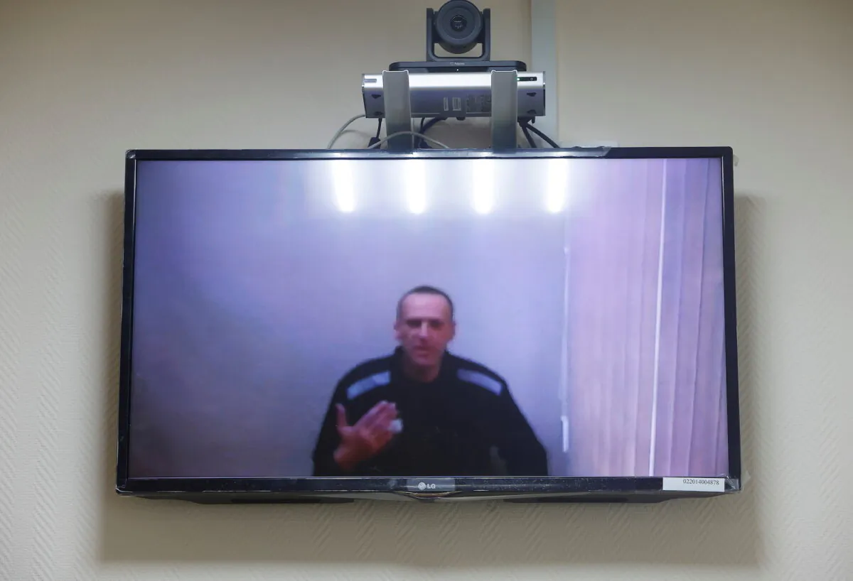 Russian opposition leader Alexei Navalny is seen on a screen via a video link during a hearing to consider his lawsuits against the penal colony over detention conditions there, at the Petushki district court in Petushki, Russia, on May 26, 2021. (Maxim Shemetov/Reuters)