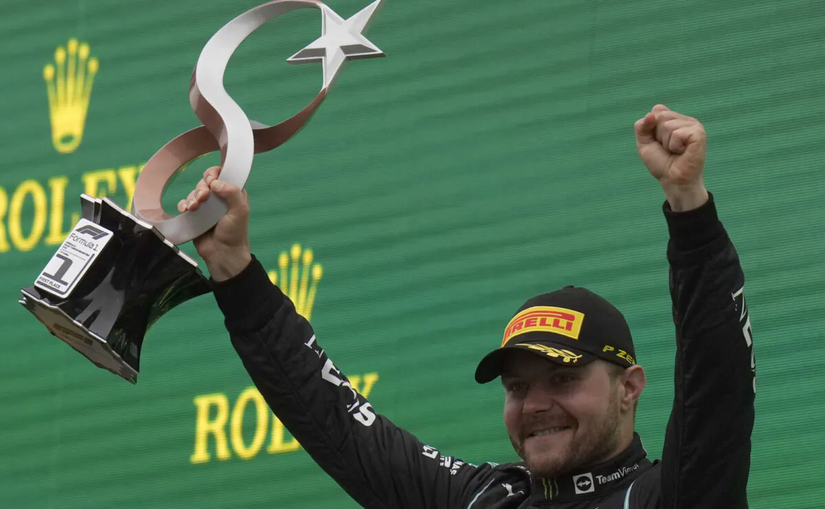 Mercedes driver Valtteri Bottas of Finland holds the trophy on the podium after winning the Turkish Formula One Grand Prix at the Intercity Istanbul Park circuit in Istanbul, Turkey, on Oct. 10, 2021. (Francisco Seco/AP Photo)