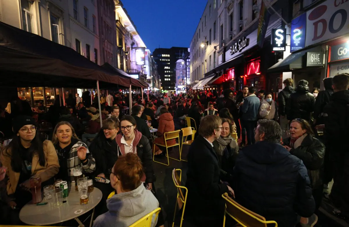 People gather for drinks and food in Old Compton Street, Soho, central London, on April 12, 2021. (Jonathan Brady/PA)