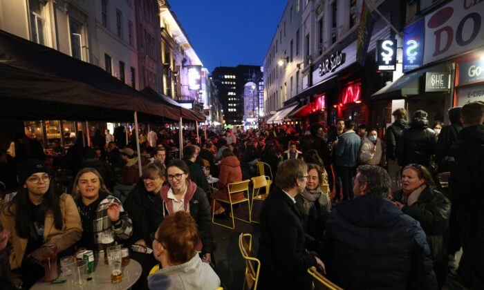People gather for drinks and food in Old Compton Street, Soho, central London, on April 12, 2021. (Jonathan Brady/PA)