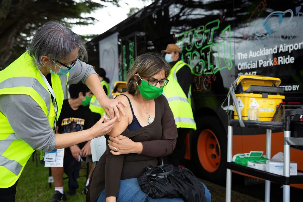 A health worker administers vaccinations at a mobile clinic in Auckland, New Zealand, on Oct. 7, 2021. (Sylvie Whinray/New Zealand Herald via AP)