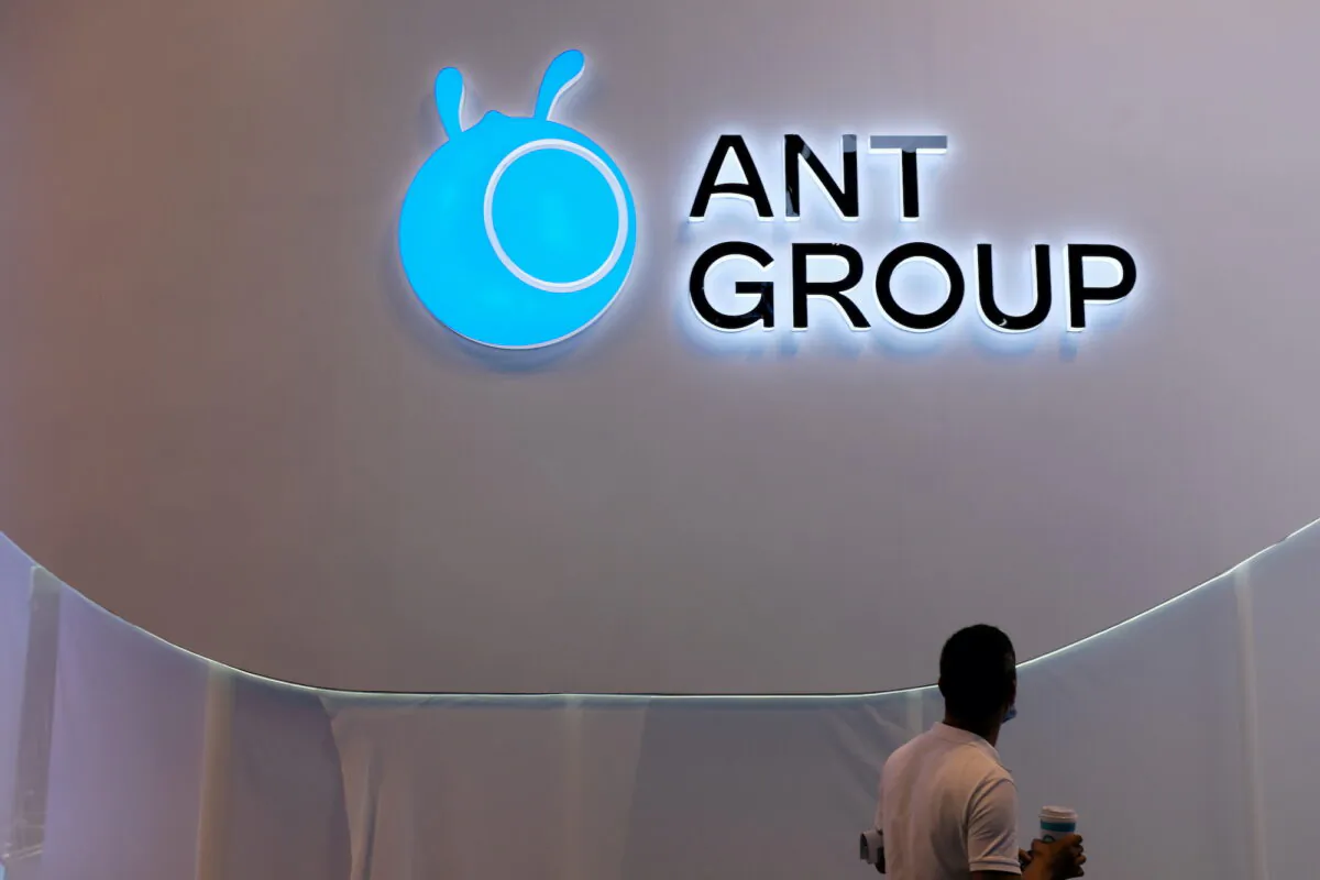 A man walks past an Ant Group logo at the World Artificial Intelligence Conference in Shanghai, China on July 8, 2021. (Yilei Sun/Reuters)