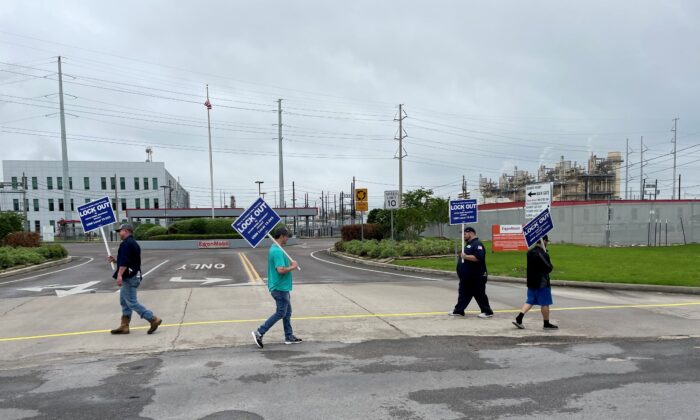 United Steelworkers union members picket outside the Exxon Mobil Beaumont, after being locked out of the plant by the company, in Beaumont, Texas on May 1, 2021. (Erwin Seba/Reuters)