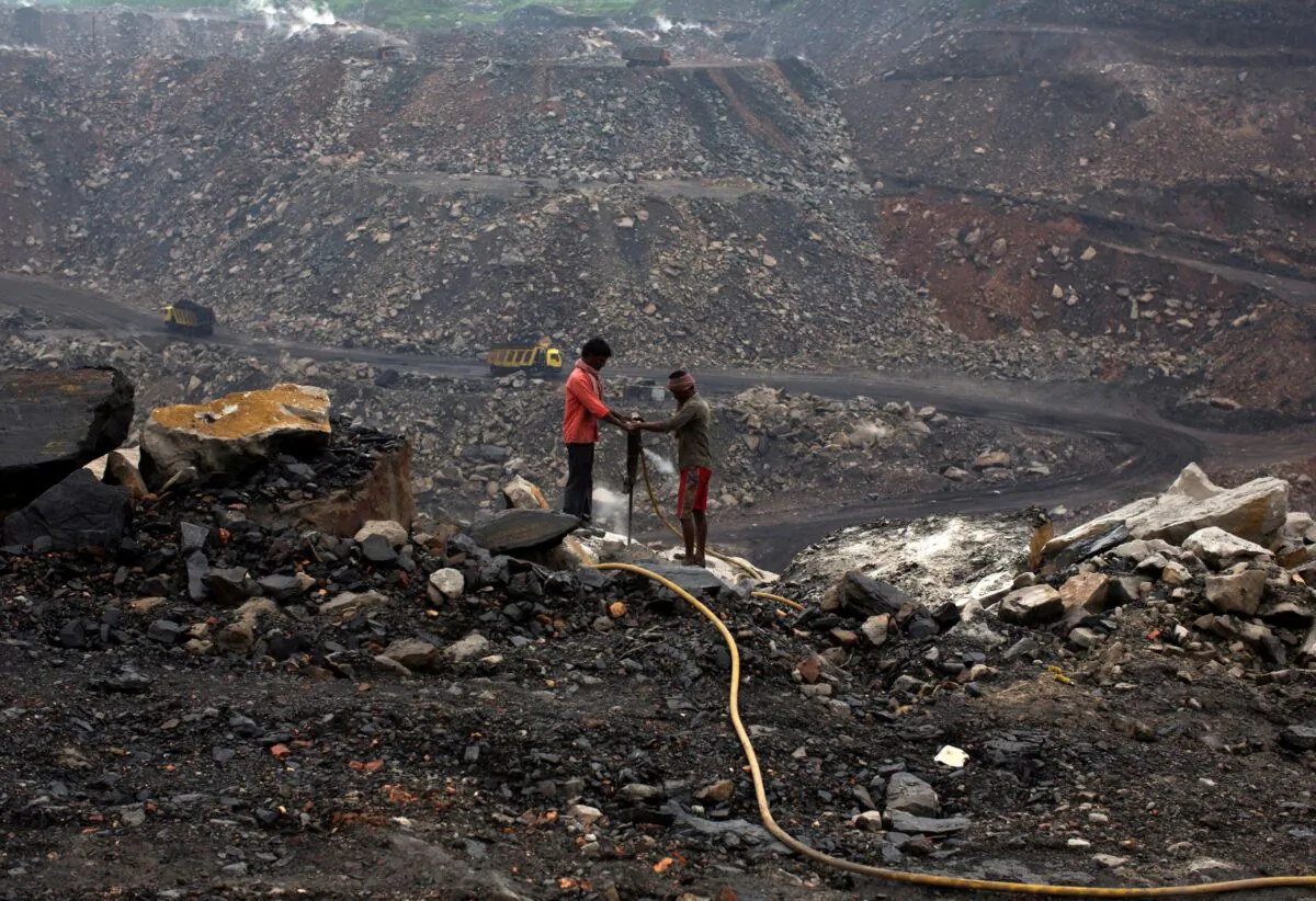 Workers drill at an open cast coal field at Dhanbad district in the eastern Indian state of Jharkhand on Sept. 18, 2012. (Ahmad Masood/Reuters)