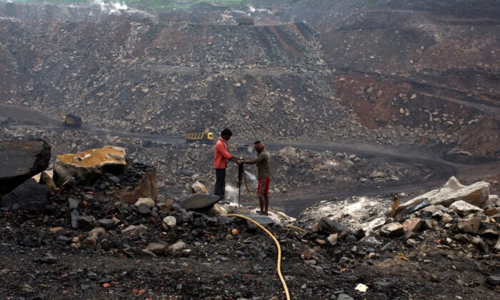 Workers drill at an open cast coal field at Dhanbad district in the eastern Indian state of Jharkhand on Sept. 18, 2012. (Ahmad Masood/Reuters)