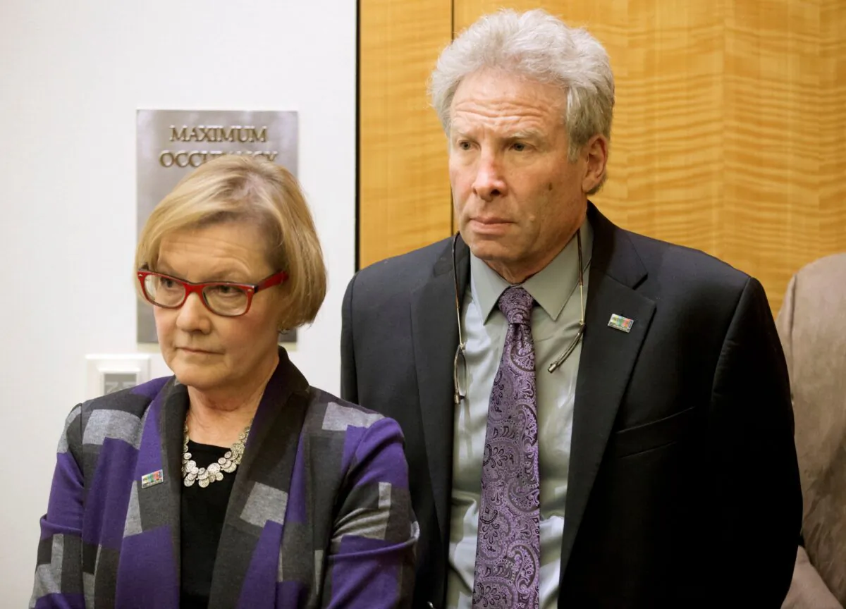 Andy Parker and his wife, Barbara, listen as Virginia Gov. Terry McAulliffe announces a compromise on a set of gun bills at the Capitol in Richmond, Va., on Jan. 29, 2016. (Steve Helber/AP Photo)