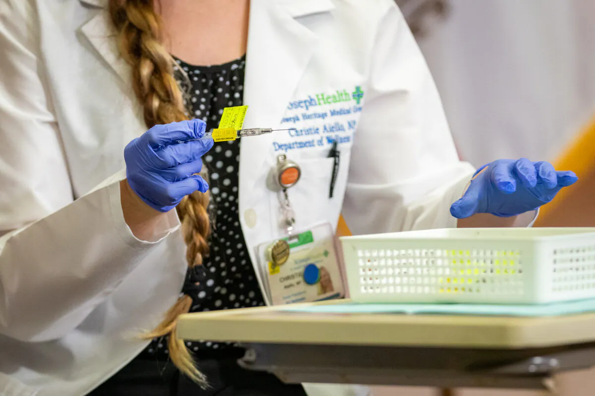 A medical worker prepares to administer a COVID-19 vaccine in Orange, Calif., on Dec. 16, 2020. (John Fredricks/The Epoch Times)
