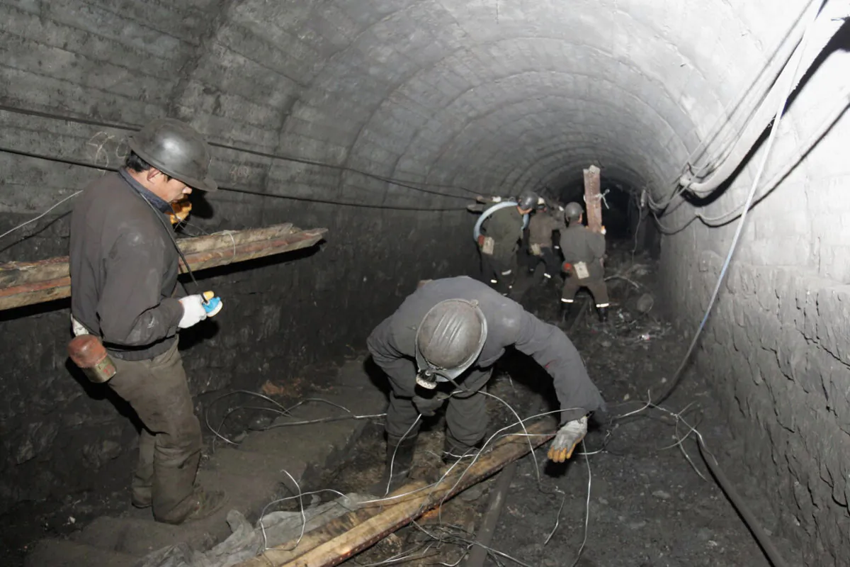 Rescue workers search for trapped miners at Xishui Colliery in Shuozhou, Shanxi Province in northern China, on March 21, 2005. A gas blast at the coal mine killed dozens.(China Photos/Getty Images)