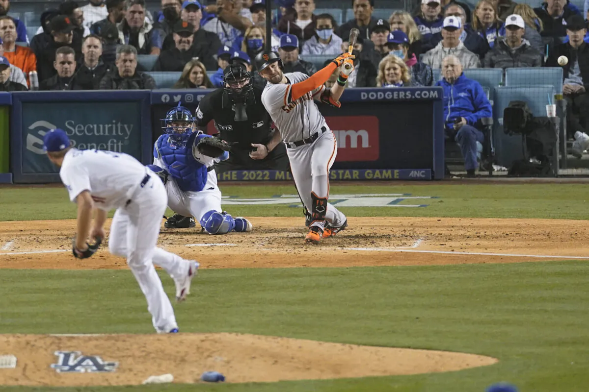 San Francisco Giants' Evan Longoria hits a solo home run off of Los Angeles Dodgers starting pitcher Max Scherzer, left, as catcher Will Smith looks on during the fifth inning of Game 3 of a baseball National League Division Series in Los Angeles on Oct. 11, 2021. (AP Photo/Marcio Sanchez)