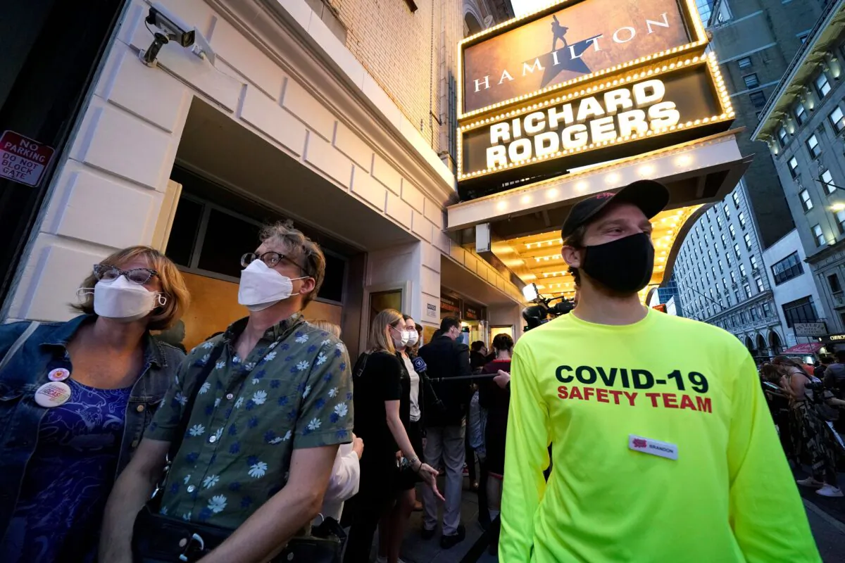 People wait to attend the Broadway musical "Hamilton" after showing their vaccination cards at the Richard Rodgers Theatre in New York on Sept. 14, 2021. (TIMOTHY A. CLARY/AFP via Getty Images)