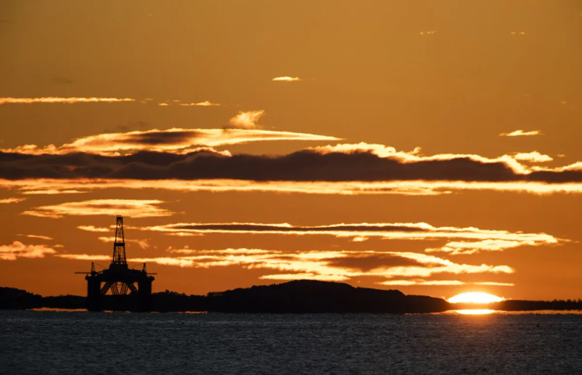 The sun rises behind a redundant oil platform moored in the Firth of Forth near Kirkcaldy, Fife, UK, in an undated file photo. (Jane Barlow/PA)