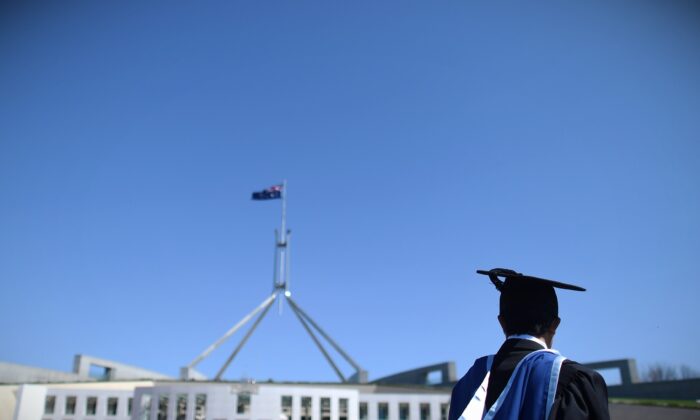 A university graduate is seen outside Parliament House in Canberra, Australia, on Oct. 1, 2015. (AAP Image/Lukas Coch)