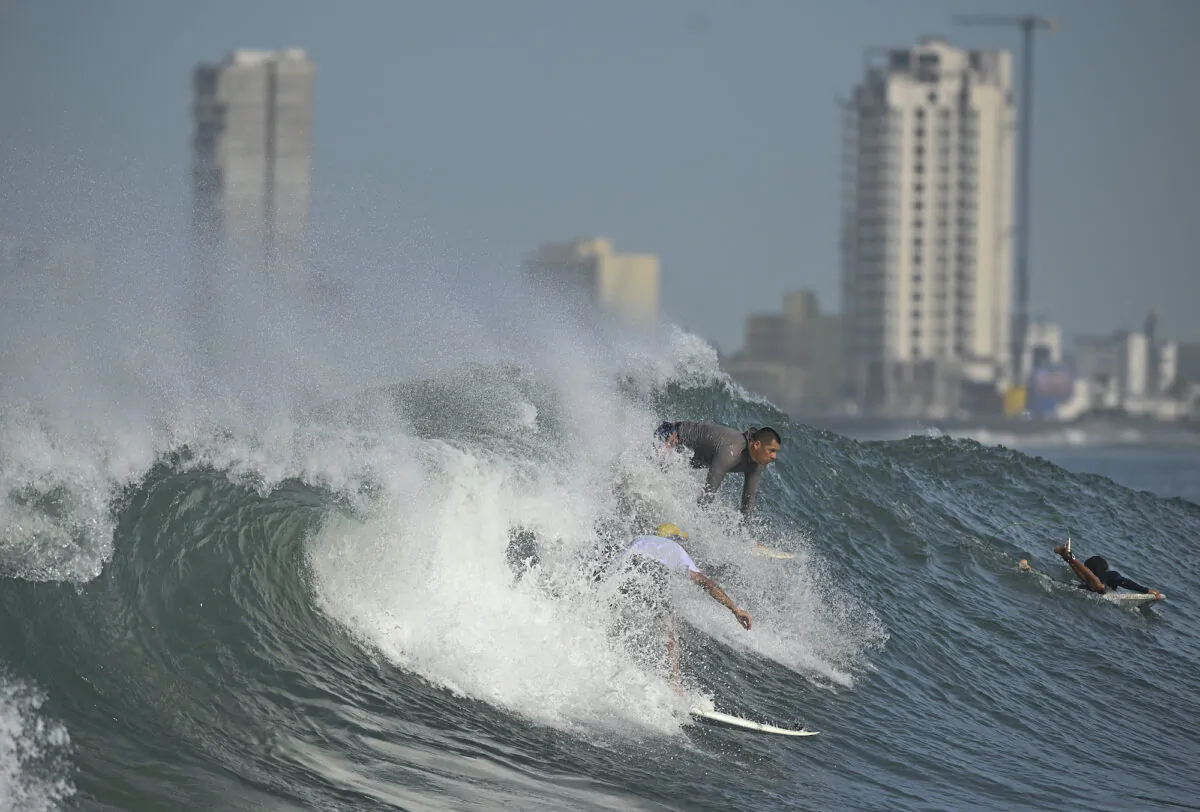 People surf at Pinitos beach prior landfall of tropical storm Pamela, in Mazatlan, Mexico, on Oct. 12, 2021. (Roberto Echeagaray/AP Photo)