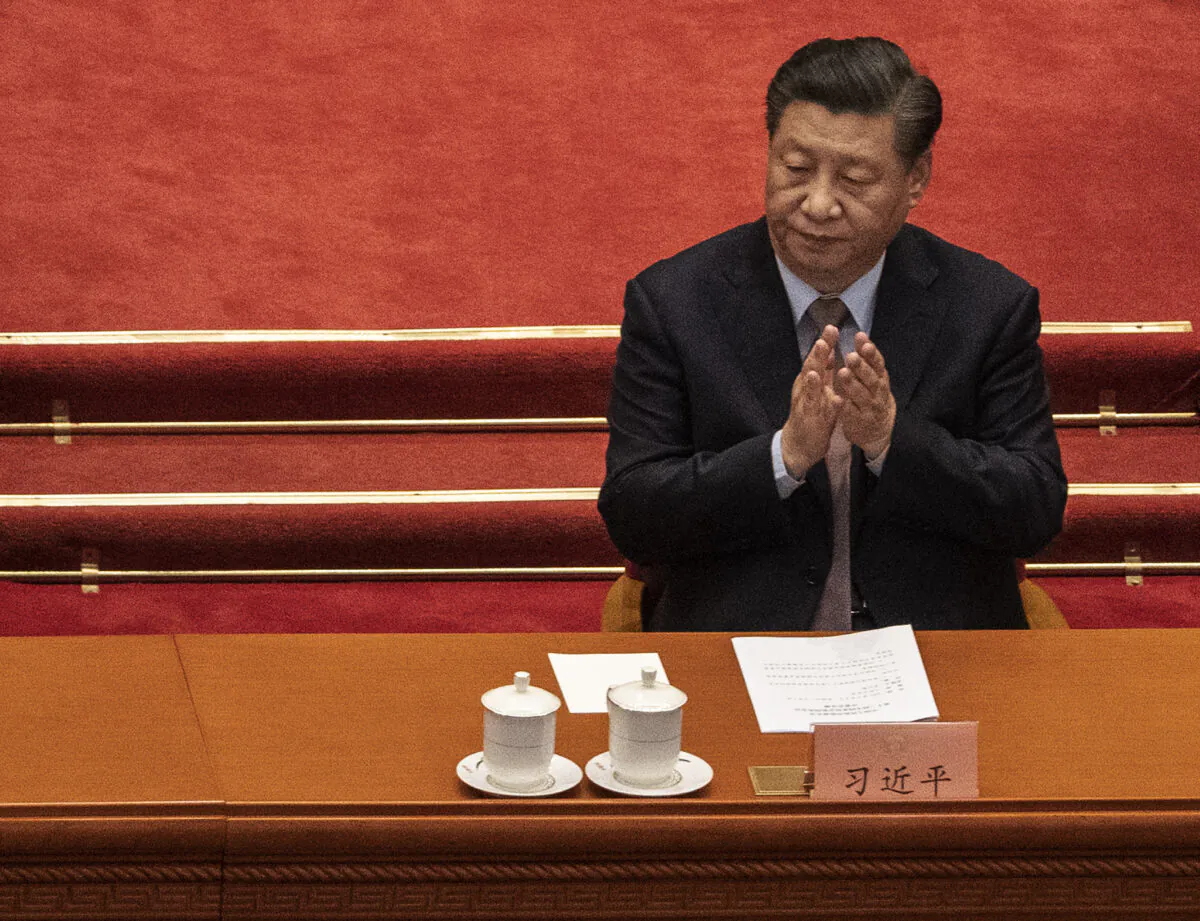 Chinese leader Xi Jinping applauds during the opening session of the Chinese People's Political Consultative Conference at the Great Hall of the People in Beijing on March 4, 2021. (Kevin Frayer/Getty Images)