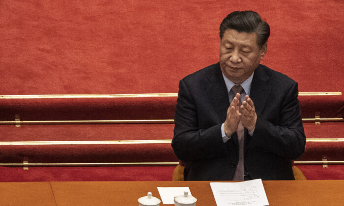 Chinese leader Xi Jinping applauds during the opening session of the Chinese People's Political Consultative Conference at the Great Hall of the People in Beijing on March 4, 2021. (Kevin Frayer/Getty Images)