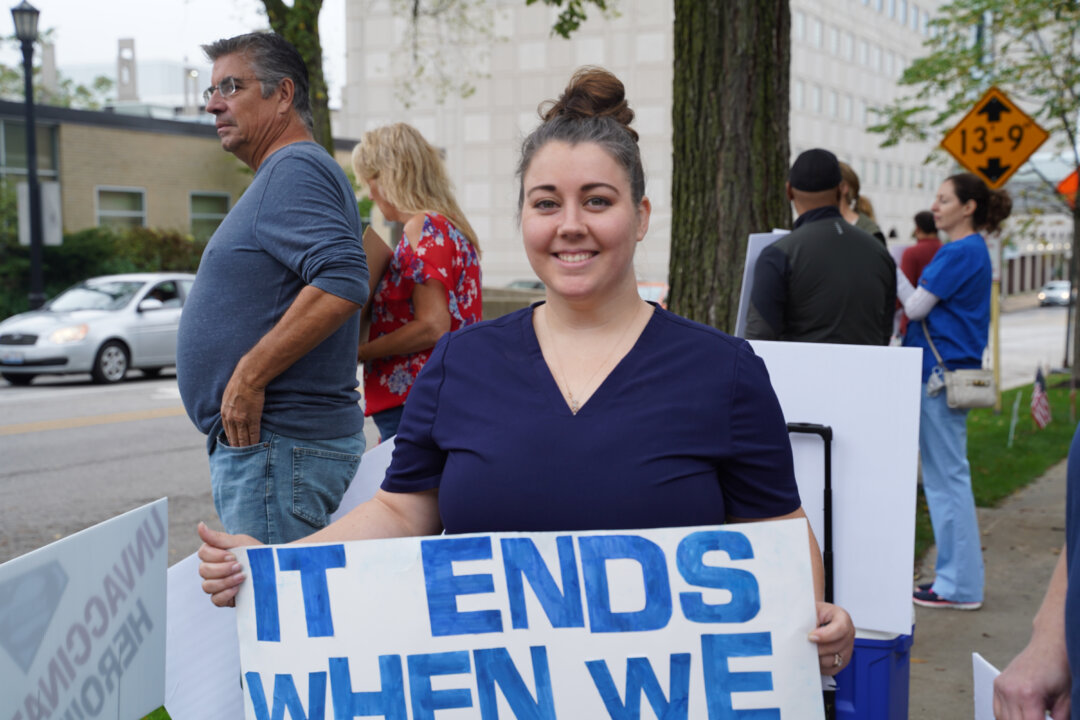Kathryn Roman, one of the organizers of the Medical Freedom Rally, stands in protest against NorthShore University HealthSystem's vaccine mandate outside Evanston Hospital in Evanston, Ill., on Oct. 12, 2021. (Cara Ding/The Epoch Times)