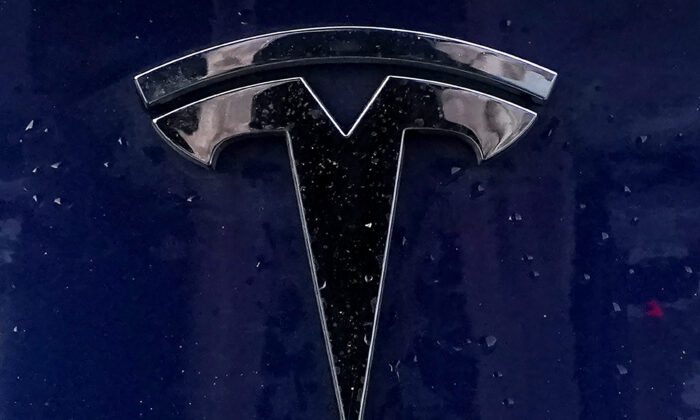 A Tesla electric vehicle emblem is affixed to a passenger vehicle in Boston, on Feb. 21, 2021.(Steven Senne/AP Photo)
