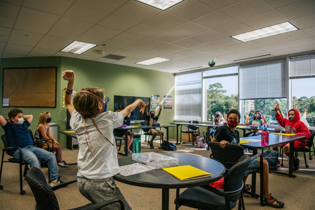 Children are seen wearing masks in compliance with a mask mandate in an activity in class at the Xavier Academy in Houston, Texas, on Aug. 23, 2021. (Brandon Bell/Getty Images)