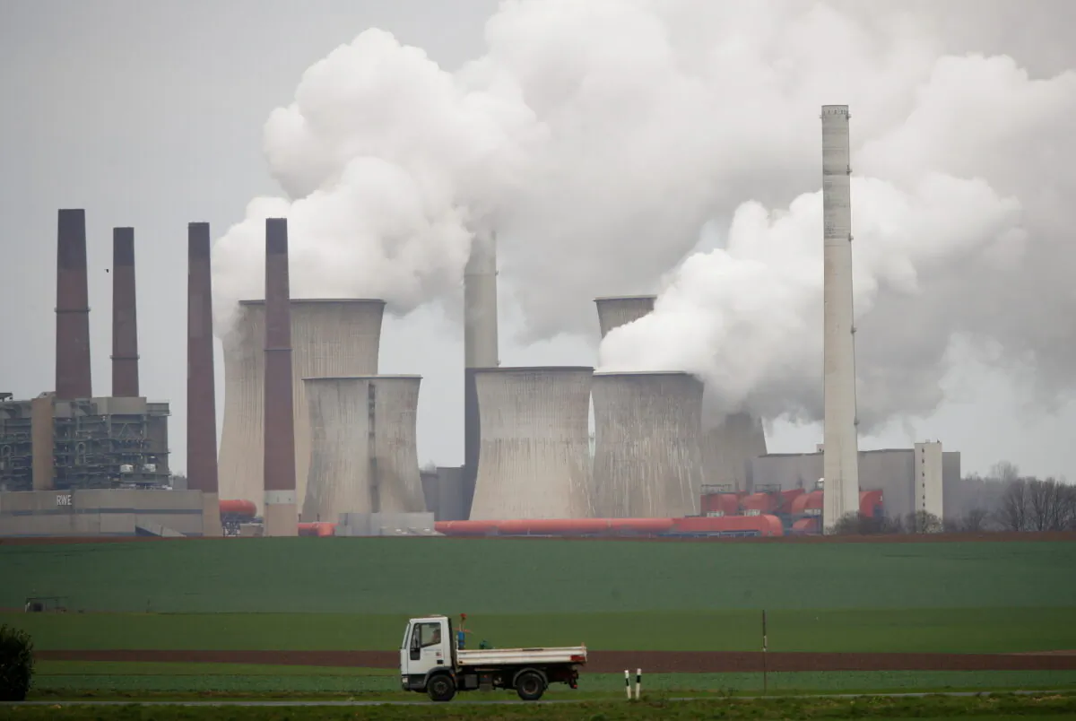 A truck drives by as steam rises from the five brown coal-fired power units of RWE, one of Europe's biggest electricity companies in Neurath, north-west of Cologne, Germany, on March 12, 2019. (Wolfgang Rattay/Reuters)