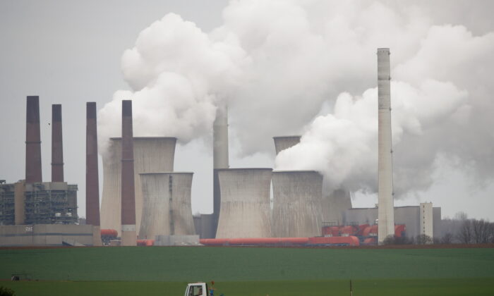 A truck drives by as steam rises from the five brown coal-fired power units of RWE, one of Europe's biggest electricity companies in Neurath, north-west of Cologne, Germany, on March 12, 2019. (Wolfgang Rattay/Reuters)