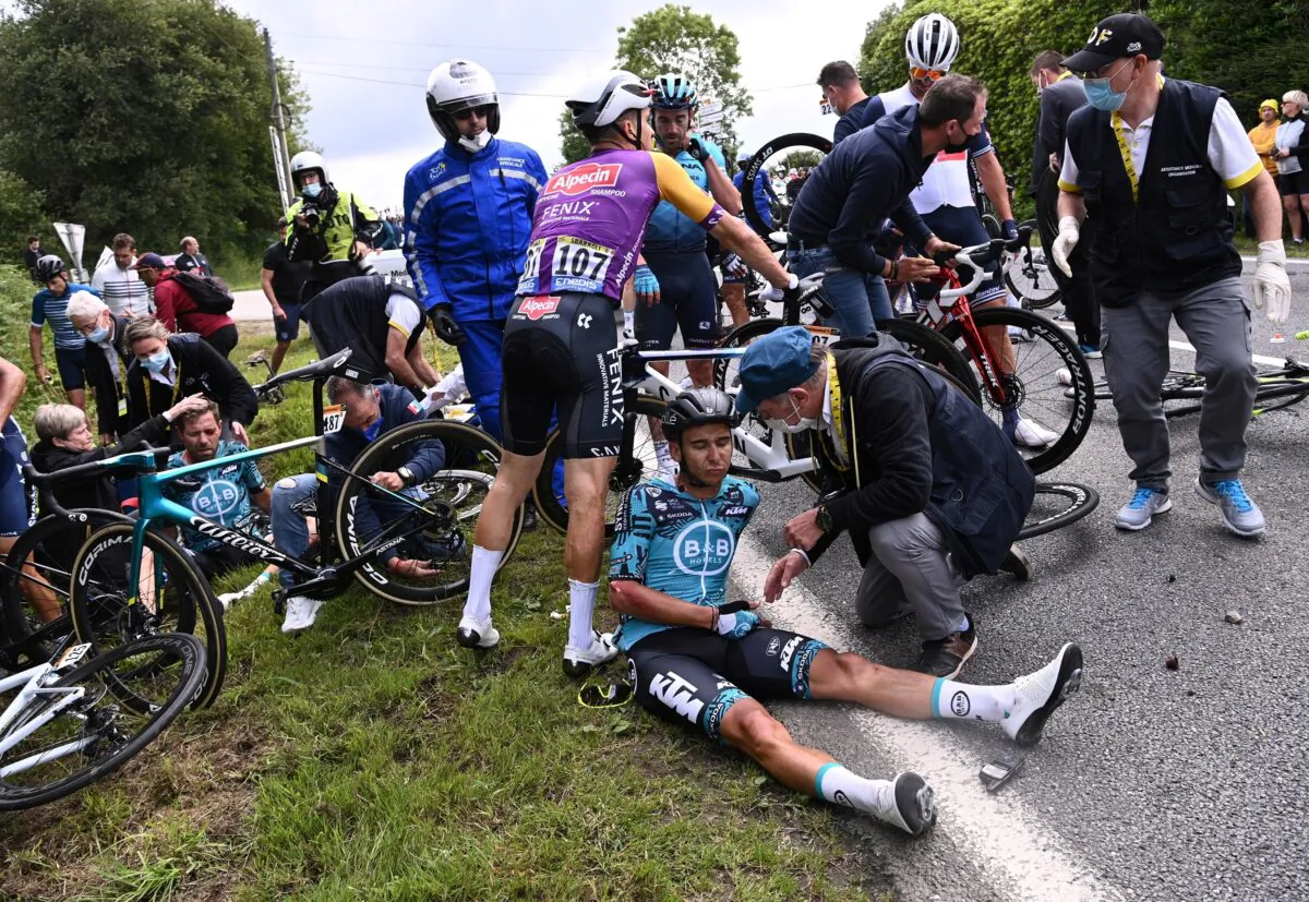 Tour de France. Rider Cyril Lemoine of France receives medical attention in Landerneau, France, on June 26, 2021. (Anne-Christine Poujoulat/pool via Reuters)