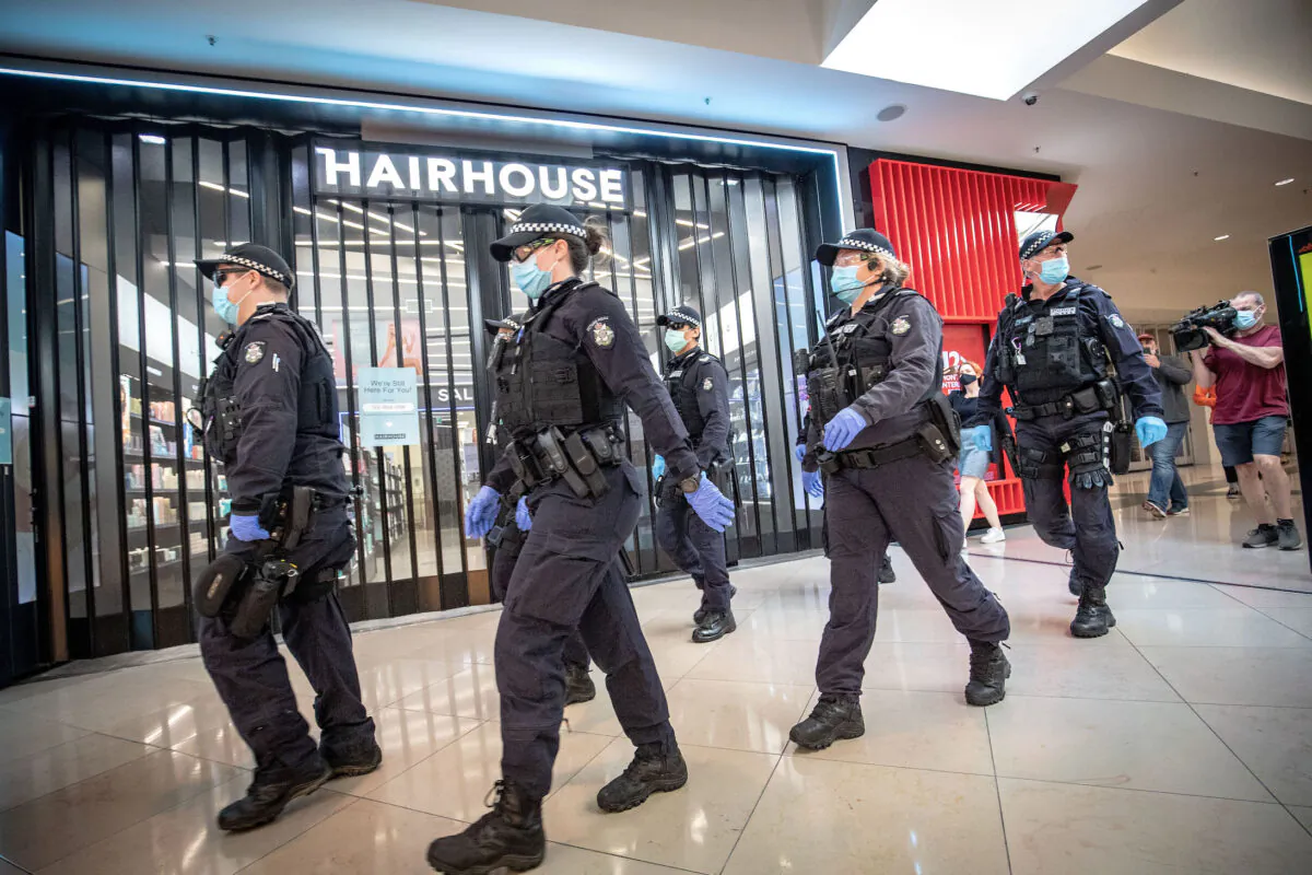Members of the Victoria Police patrol through Chadstone Shopping Centre in Melbourne, Australia, on Sept. 20, 2020. (Darrian Traynor/Getty Images)
