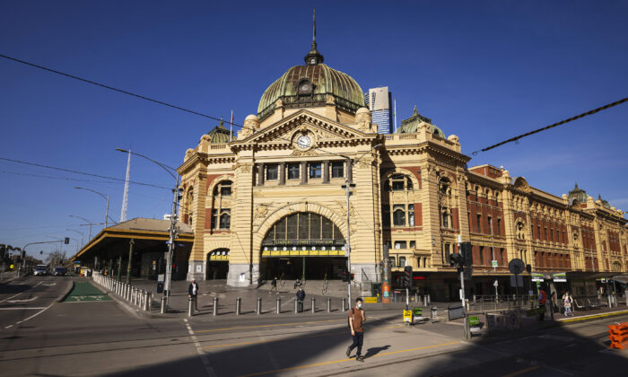 People cross a quiet Flinders Street in Melbourne on Sept. 1, 2021.  (Daniel Pockett/Getty Images)