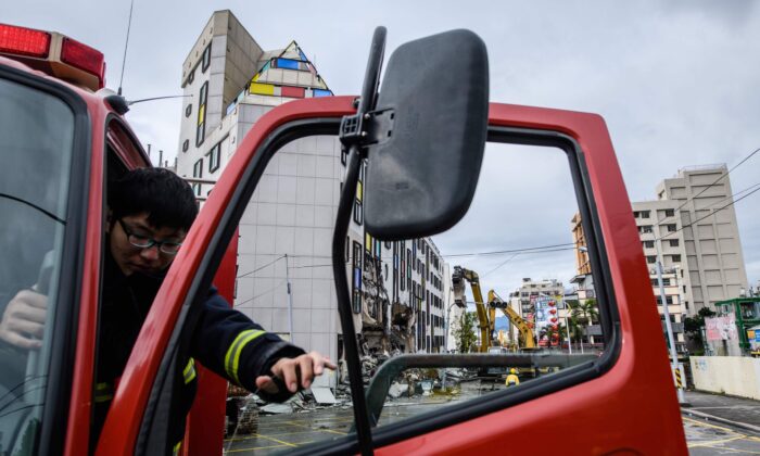 A fireman steps out of his firetruck in the Taiwanese city of Hualien on Feb. 9, 2018. (ANTHONY WALLACE/AFP via Getty Images)