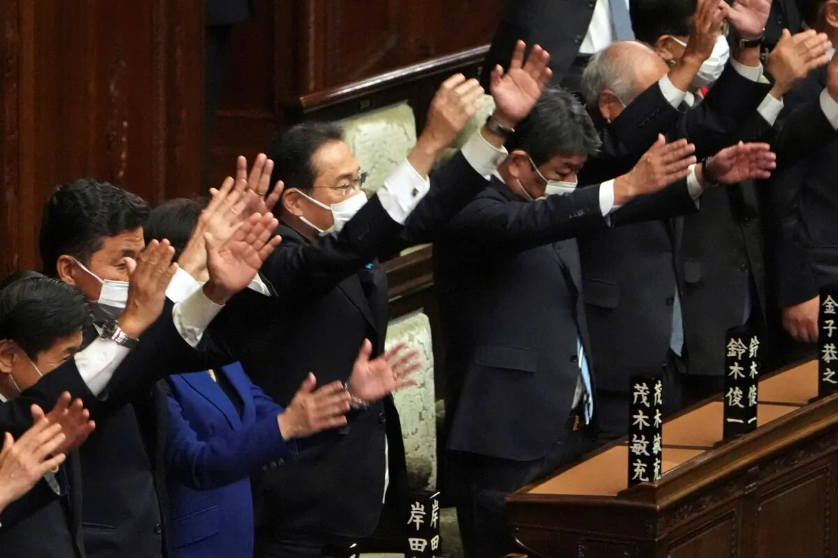 Japanese Prime Minister Fumio Kishida (C) and other lawmakers give three cheers after dissolving the lower house, the more powerful of the two parliamentary chambers, during an extraordinary Diet session at the lower house of parliament in Tokyo, on Oct. 14, 2021. (Eugene Hoshiko/AP Photo)