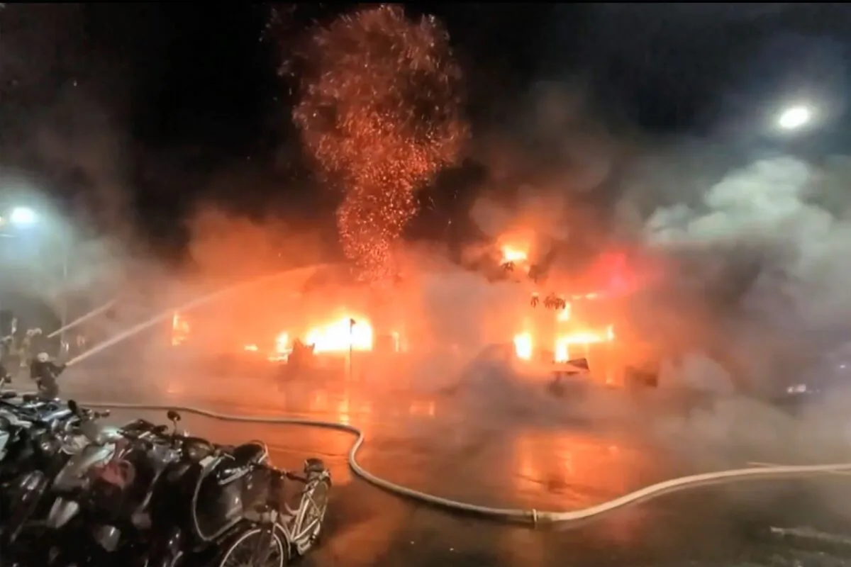 In this image taken from video by Taiwan's EBC, firefighters battle a blaze at a building. A fire engulfed a 13-story building overnight in Kaohsiung, in southern Taiwan on Oct. 14, 2021.  (EBC via AP)