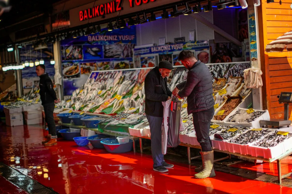 A fishmonger talks to a client at Karakoy fish market in Istanbul, Turkey,  on Oct. 14, 2021. (Francisco Seco/AP Photo)