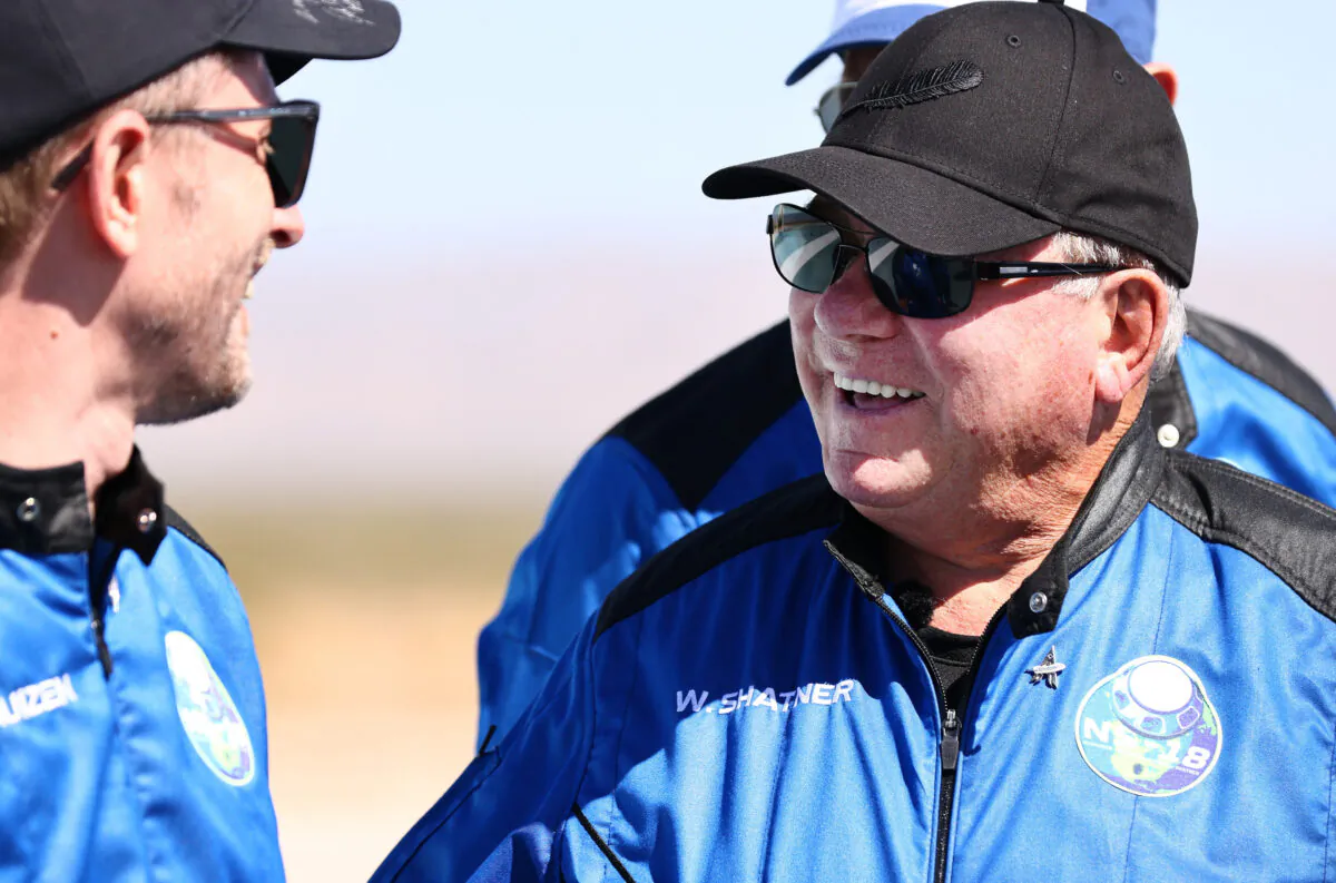 Star Trek actor William Shatner (right) smiles as Planet Labs co-founder Chris Boshuizen looks on during a media availability on the landing pad of Blue Origin’s New Shepard after they flew into space, near Van Horn, Texas, on Oct. 13, 2021. (Mario Tama/Getty Images)