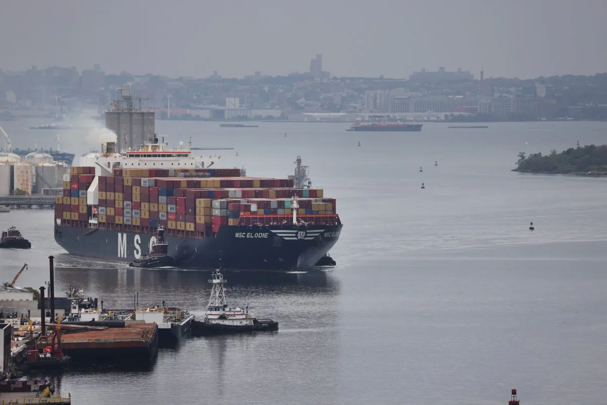A cargo ship moves toward the Bayonne Bridge as it heads into port in Bayonne, N.J., on Oct. 13, 2021. The breakdown in global supply chains foretells a big change coming, says John Mills. (Spencer Platt/Getty Images)