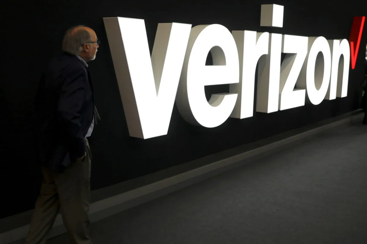 A man stands next to the logo of Verizon at the Mobile World Congress in Barcelona, Spain, on Feb. 26, 2019. (Sergio Perez/REUTERS)