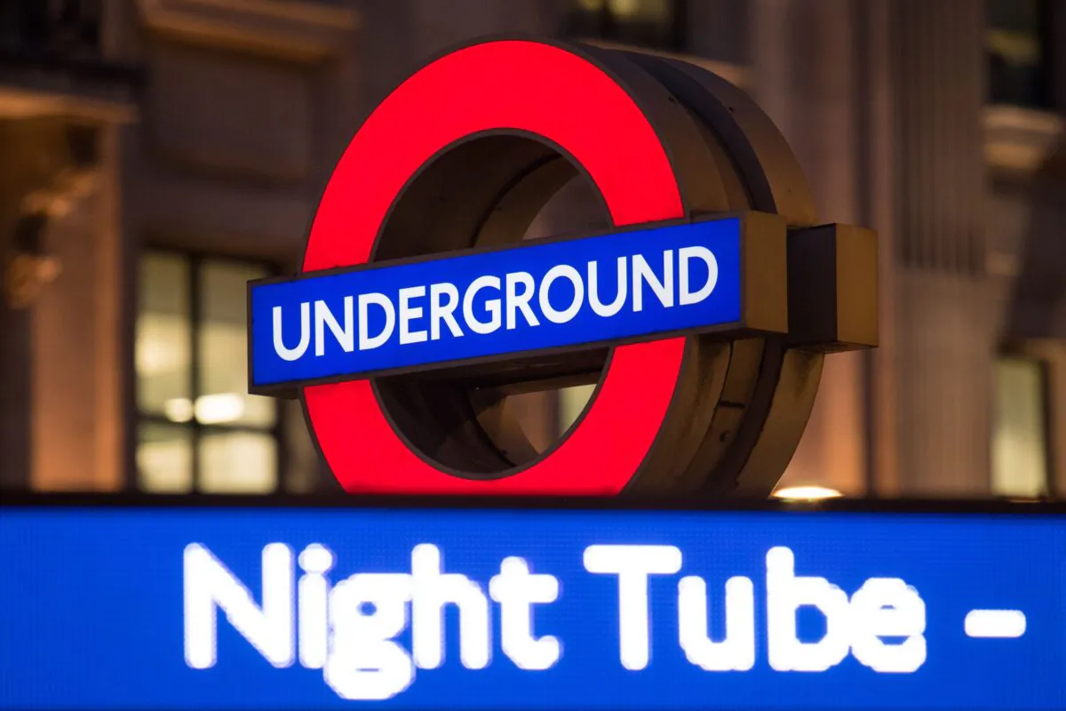 A London Underground roundel alongside an advert for the night tube at Oxford Circus underground station, in London on Aug. 17, 2016. (Dominic Lipinski/PA)