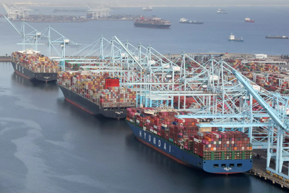 Shipping containers are unloaded from ships at a container terminal at the Port of Long Beach-Port of Los Angeles complex in Los Angeles, California, on April 7, 2021. (Lucy Nicholson/Reuters)
