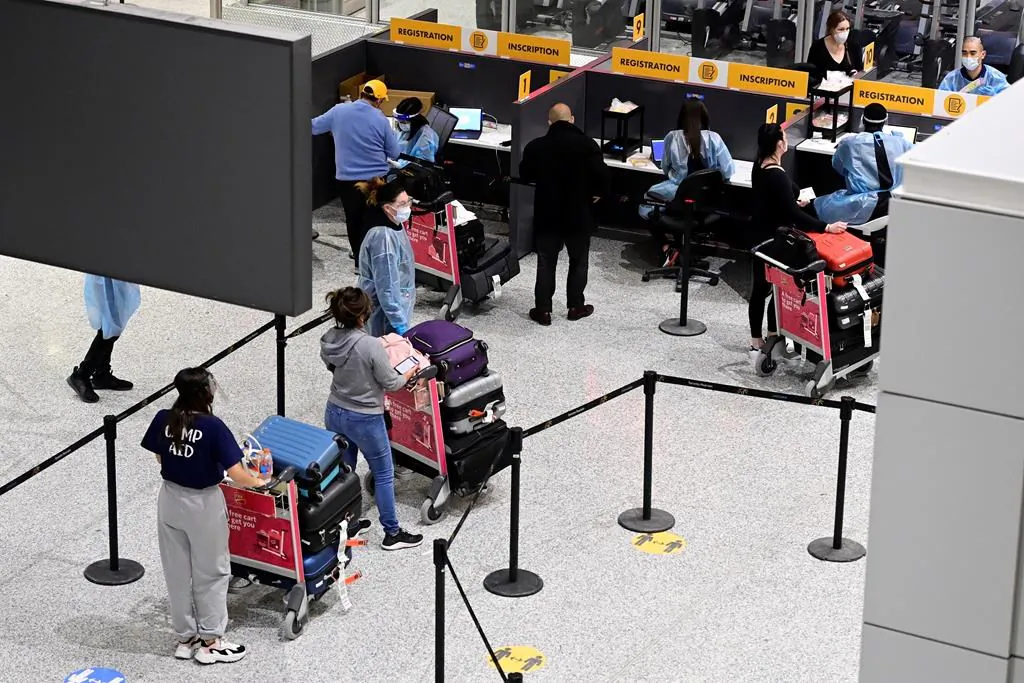 Travellers, who are not affected by new quarantine rules, arrive at Terminal 3 at Pearson Airport in Toronto on February 22, 2021. (The Canadian Press/Frank Gunn)
