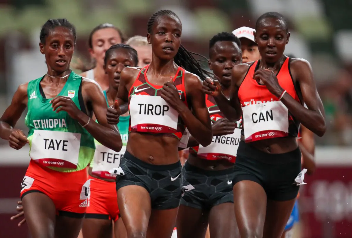 Ethiopia's Ejgayehu Taye (L), Kenya's Agnes Jebet Tirop (C), and Turkey's Yasemin Can (R), compete in the women's 5000m heats during the Tokyo 2020 Olympic Games at the Olympic Stadium in Tokyo, Japan, on July 30, 2021. (Jewel Sama/GettyImages for AFP) 