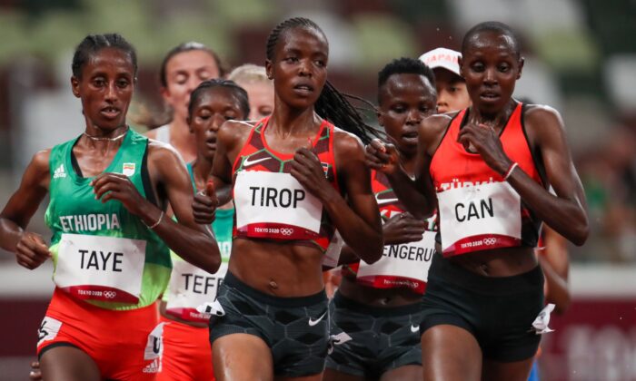 Ethiopia's Ejgayehu Taye (L), Kenya's Agnes Jebet Tirop (C), and Turkey's Yasemin Can (R), compete in the women's 5000m heats during the Tokyo 2020 Olympic Games at the Olympic Stadium in Tokyo, Japan, on July 30, 2021. (Jewel Sama/GettyImages for AFP) 