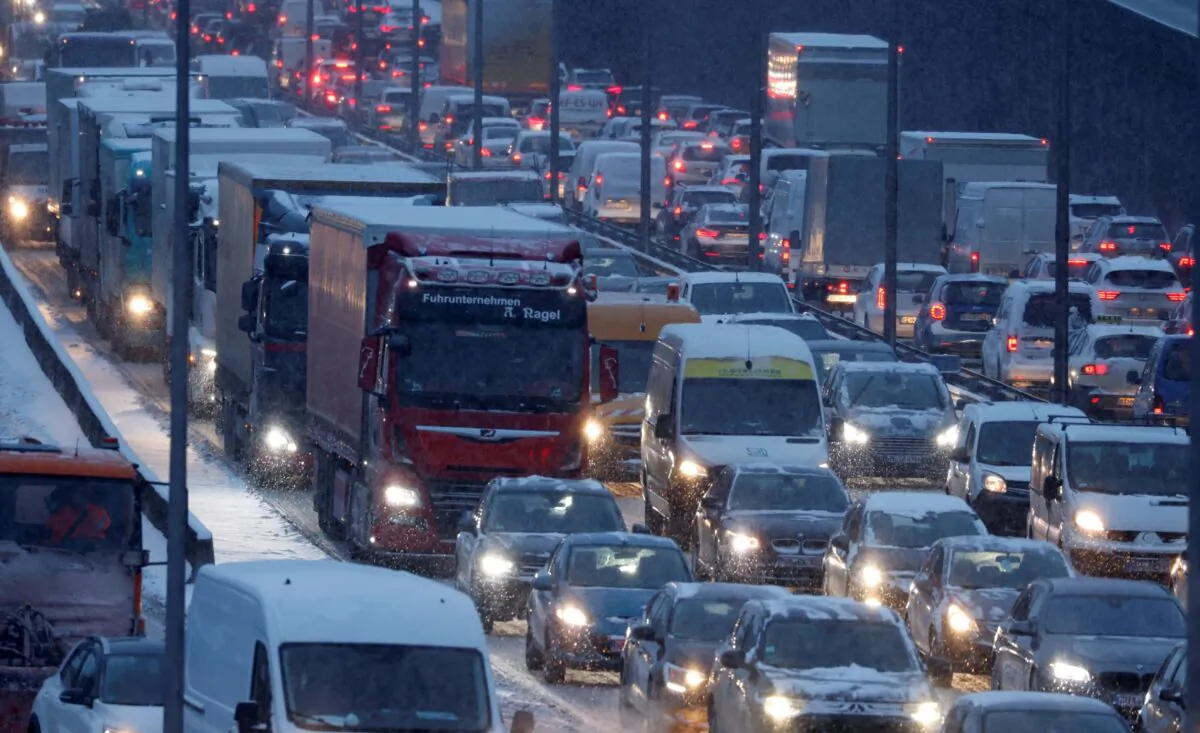 Cars are pictured at rush hour traffic on A100 highway during a snowfall in Berlin, Germany on Feb. 8, 2021. (Fabrizio Bensch/Reuters)