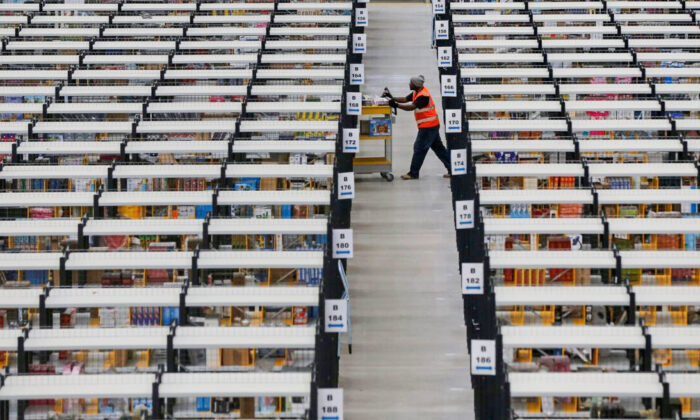 A worker collects orders at Amazon's fulfillment center in Rugeley, central England, on Dec. 11, 2012. (Phil Noble/Reuters)