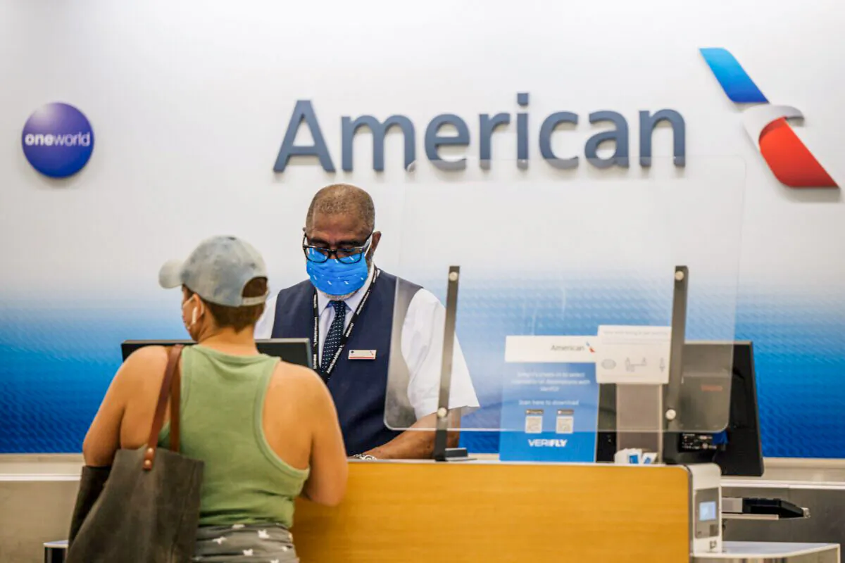 A customer is helped at an American Airlines check-in counter at the George Bush Intercontinental Airport in Houston, Texas, on Aug. 5, 2021. (Brandon Bell/Getty Images)