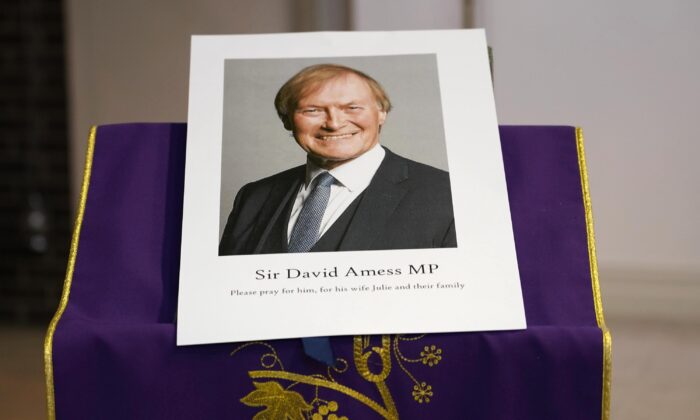 An image of murdered UK Conservative lawmaker David Amess is displayed near the altar in St Peters Catholic Church before a vigil in Leigh-on-Sea, England, on Oct. 15, 2021. (Alberto Pezzali/AP Photo)