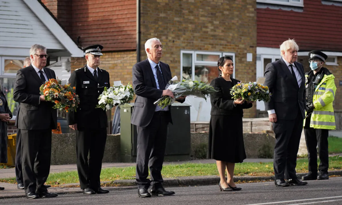 (L–R): Police, Fire, and Crime Commissioner for Essex Roger Hirst, Chief Constable Ben-Julian Harrington, Speaker of the House Sir Lindsay Hoyle, Home Secretary Priti Patel, and Prime Minister Boris Johnson at the scene where Conservative MP Sir David Amess was stabbed to death near Belfairs Methodist Church in Leigh-on-Sea, Essex, England, on Oct. 16, 2021. (Essex Police via PA)