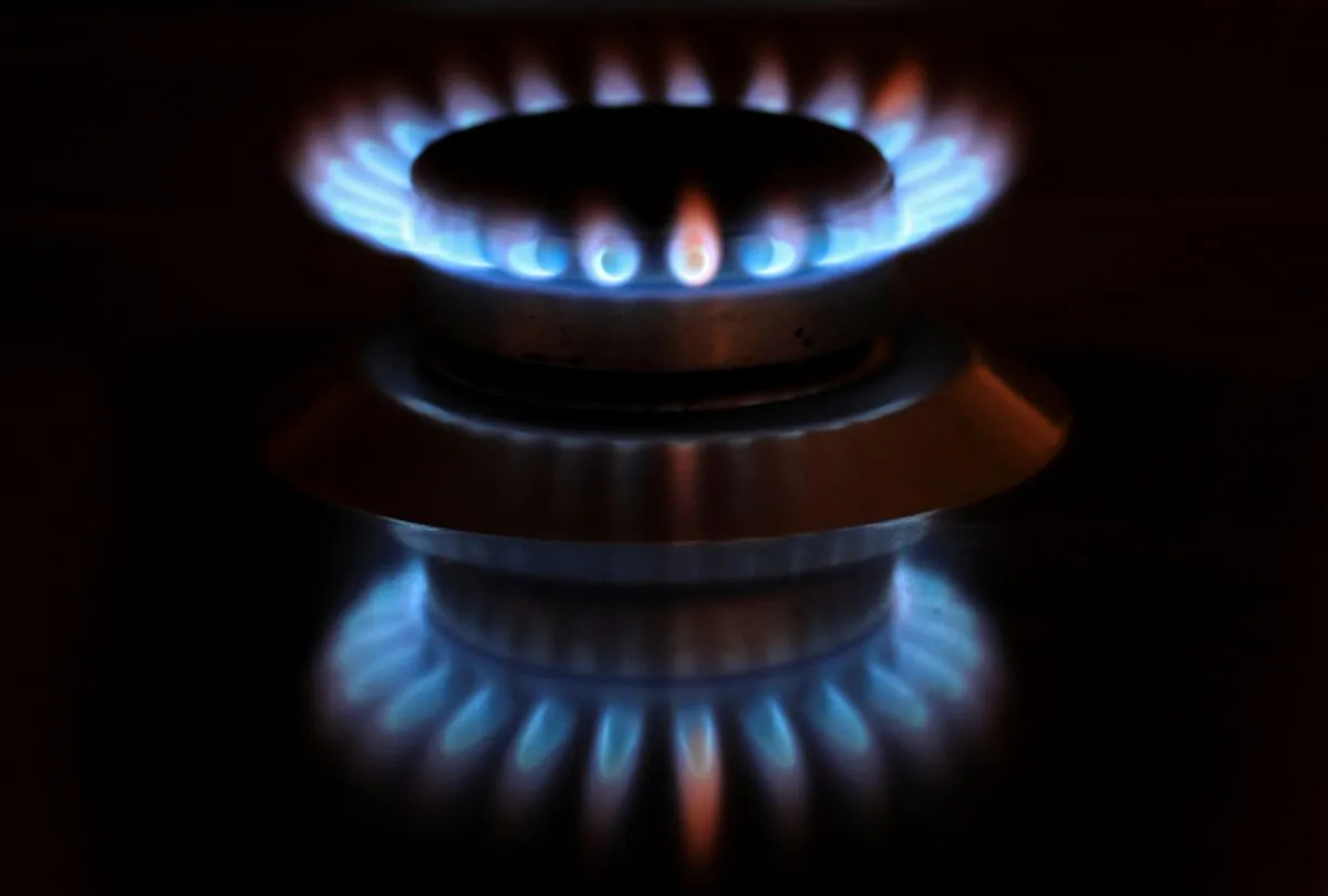 Flames from a gas burner are reflected on a cooker in a private home in Bad Honnef near Bonn, Germany on Oct. 11, 2021. (Wolfgang Rattay/Reuters)