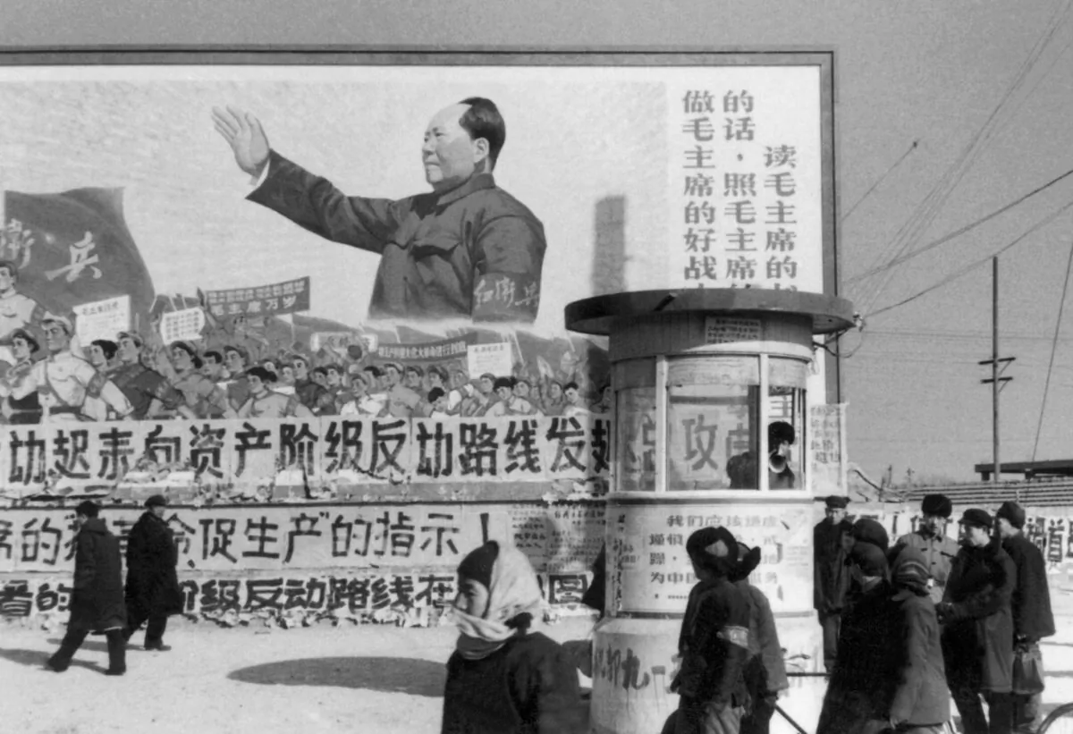 Residents walk past a poster showing Chairman Mao Zedong during the "Great Proletarian Cultural Revolution," in Beijing in February 1967. (Jean Vincent/AFP via Getty Images)