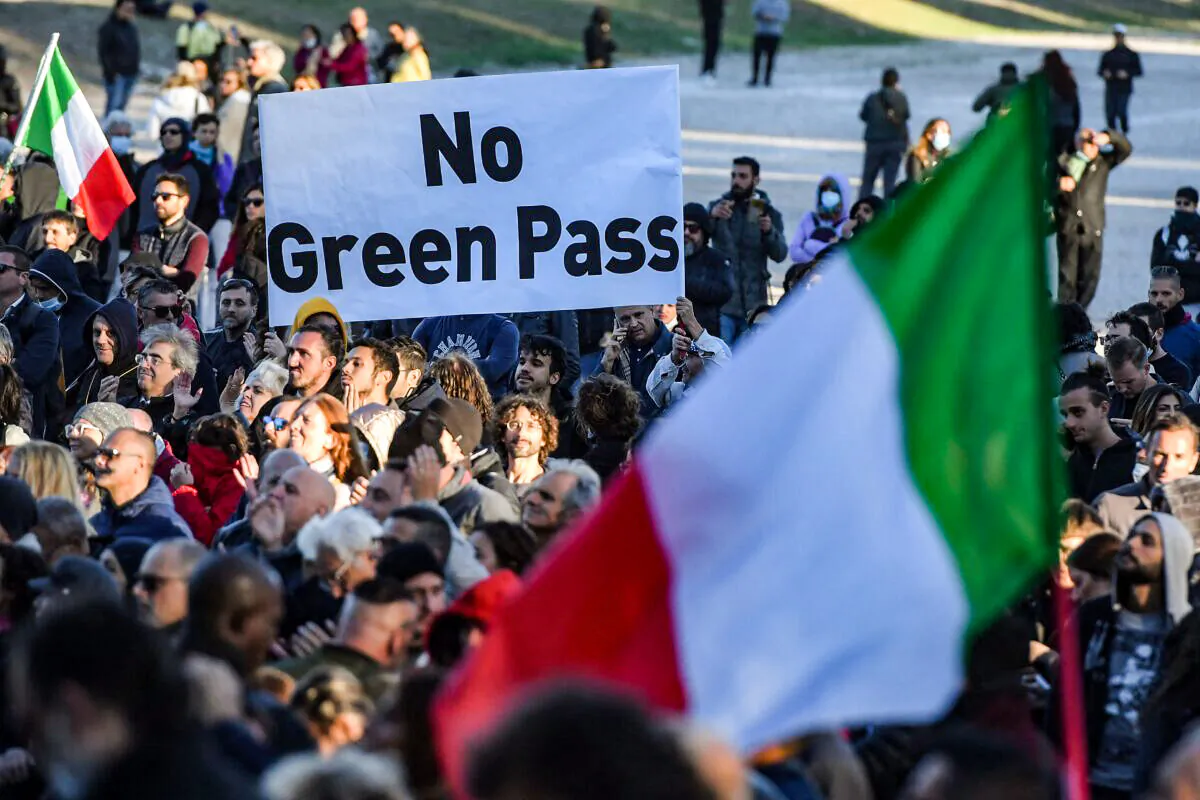 People gather during a protest against the so-called Green Pass on October 15, 2021 at Circo Massimo in Rome, as new coronavirus restrictions for workers come into effect. - Italy braced for nationwide protests, blockades and potential disruption on October 15, 2021 as all workers must show a so-called Green Pass, offering proof of vaccination, recent recovery from Covid-19 or a negative test, or face being declared absent without pay. (Photo by Tiziana FABI / AFP) (Photo by TIZIANA FABI/AFP via Getty Images)
