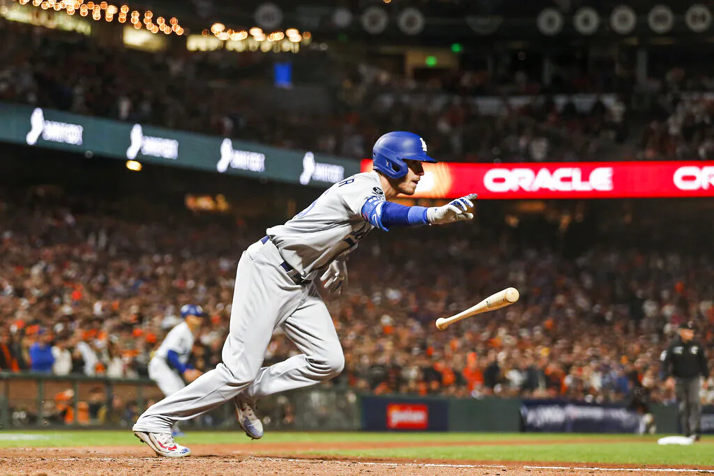 Los Angeles Dodgers' Cody Bellinger runs to first base after hitting an RBI-single against the San Francisco Giants during the ninth inning of Game 5 of a baseball National League Division Series Thursday, Oct. 14, 2021, in San Francisco. (AP Photo/Jed Jacobsohn)