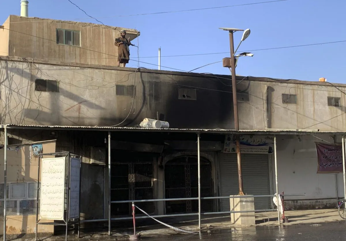 A Taliban fighter stands guard on the top of a mosque following a suicide bomber attack in the city of Kandahar, Afghanistan, on Oct. 15, 2021. (Sidiqullah Khan/AP Photo)